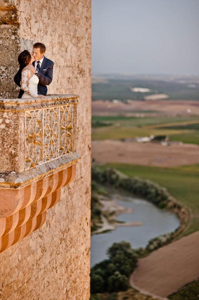 Wedding couple on castle balcony